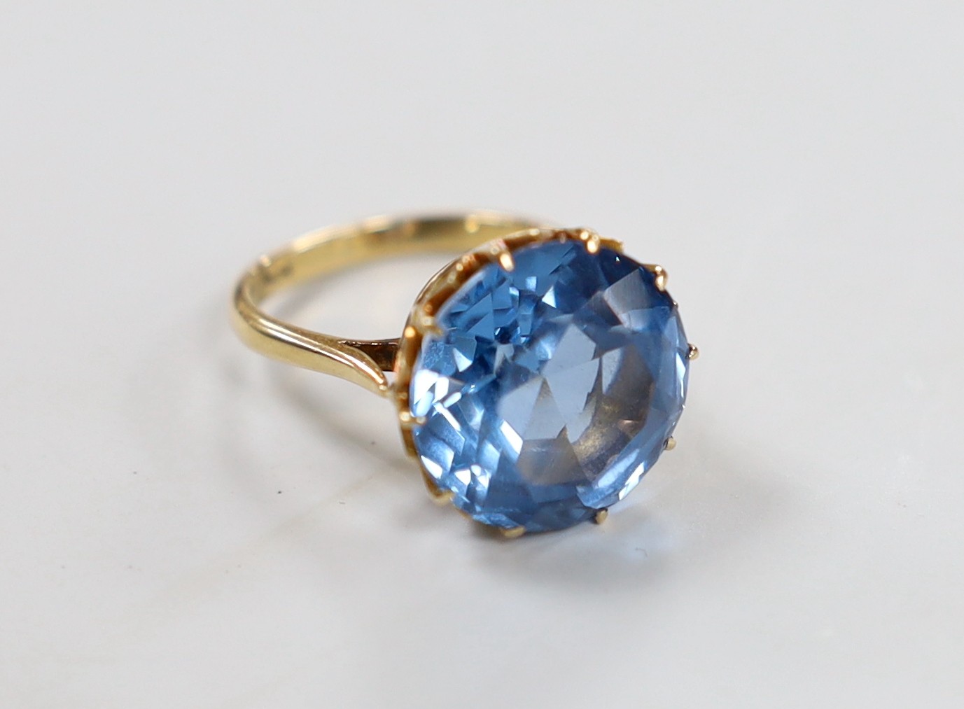 An 10k and blue paste? set ring, size K/L, gross weight 7 grams.